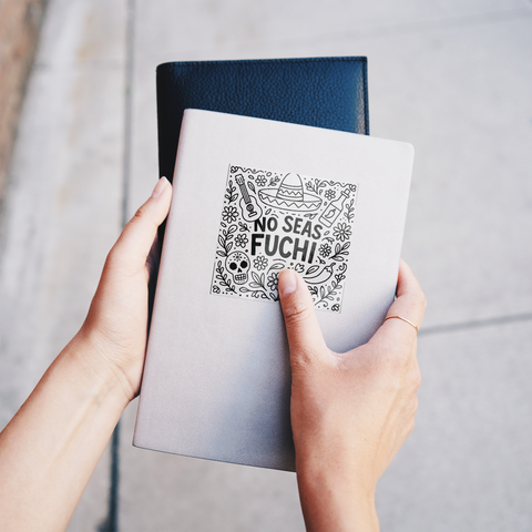 No_Seas_Fuchi_Sticker_ClearSquareSticker_Notebook_Mockup.png
