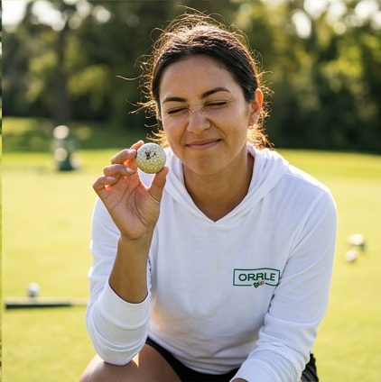A golfer wearing Orale | Hooded long-sleeve tee on the course