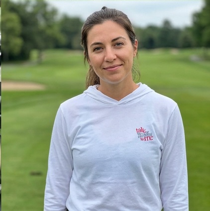 A golfer wearing Talk Birdie to Me | Hooded Long Sleeve Tee Sweater on the course