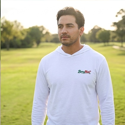A golfer wearing Berry Nais | Hooded Long Sleeve Tee Sweater on the course