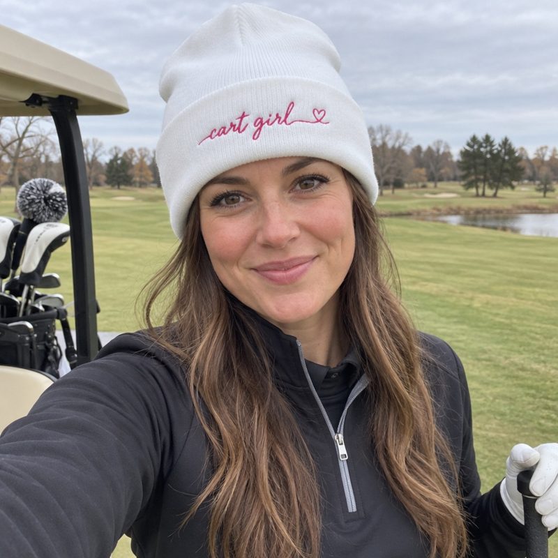 A golfer wearing Cart Girl Long Cursive Logo - Beanie on the course