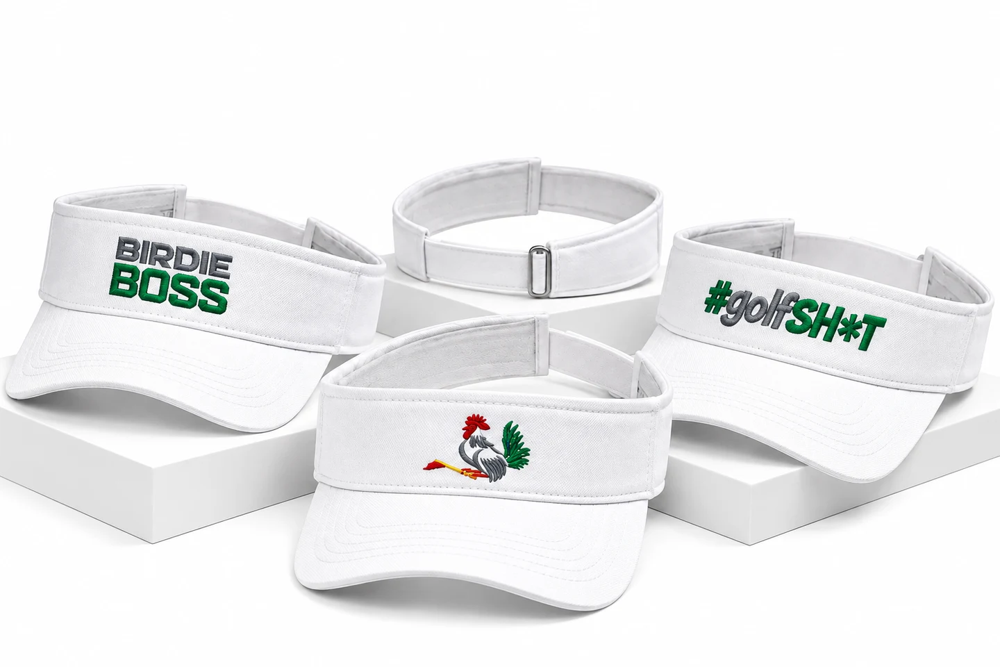White embroidered golf visors including Birdie Boss